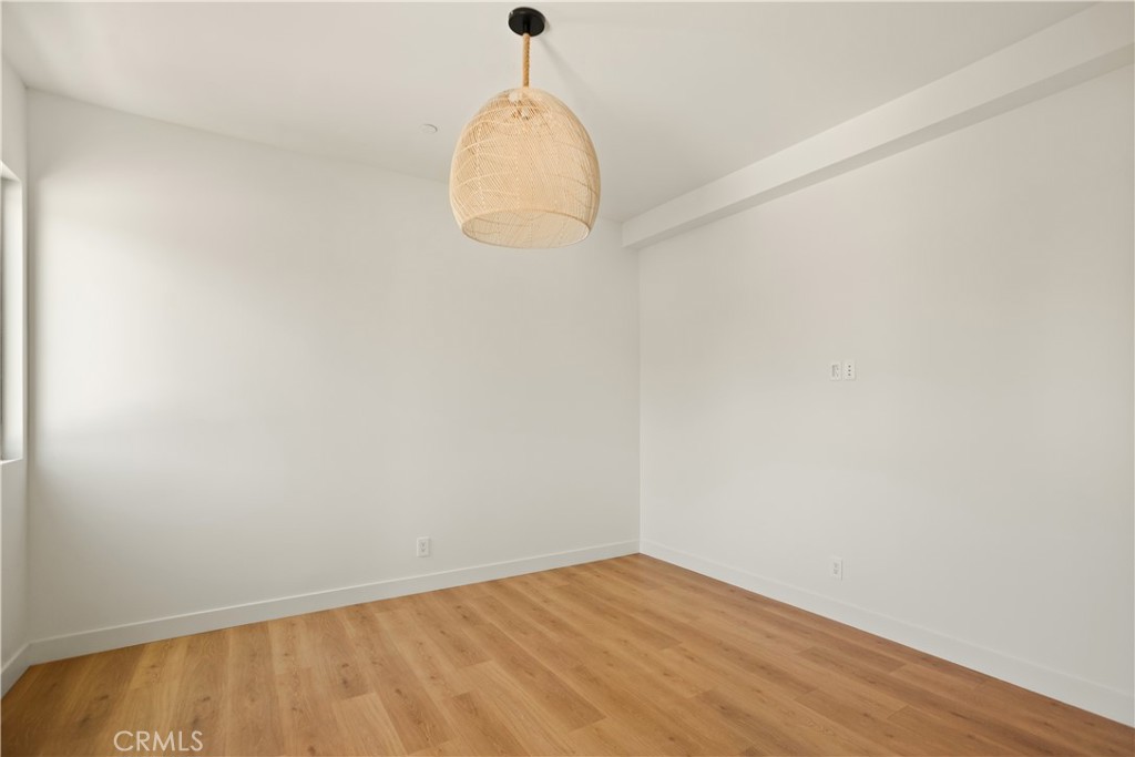 2671 1/2 Benedict Street Los Angeles, CA 90039 - Photo 6 of 39 an empty room with wooden floor and windows