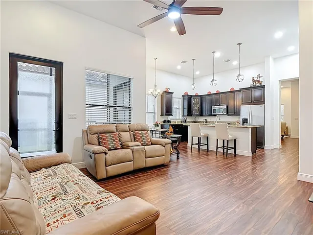 a living room with furniture and kitchen view