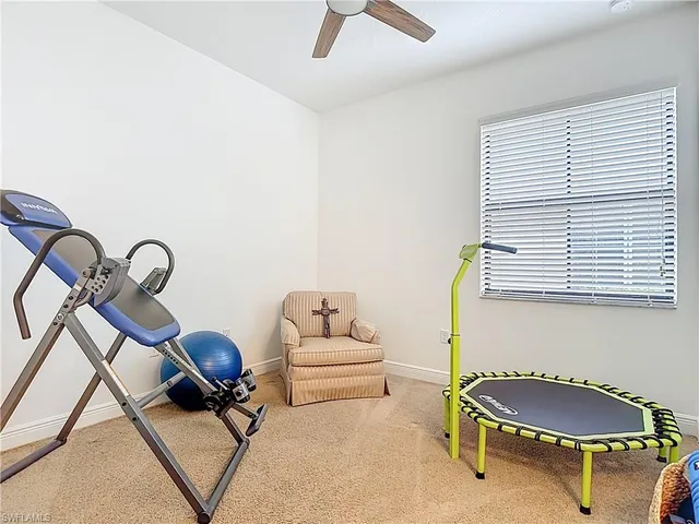 a living room with furniture a air conditioner and a window