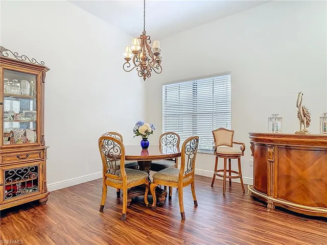a view of a dining room with furniture wooden floor and chandelier