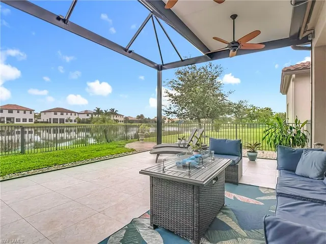 a view of a patio with couches under an umbrella
