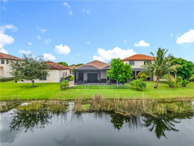 a view of a house with a big yard and potted plants