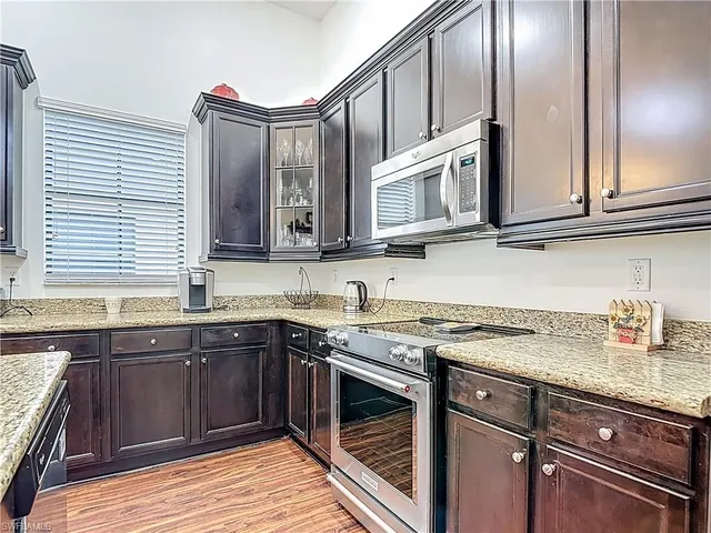a kitchen with stainless steel appliances granite countertop a sink and stove top oven