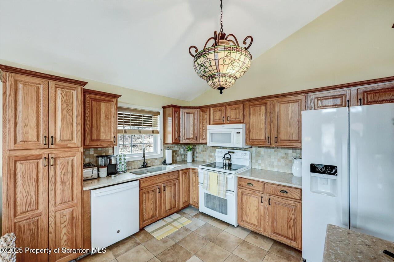 41 Show Kase Road Forest City, PA 18421 - Photo 23 of 81 a kitchen with stainless steel appliances granite countertop a refrigerator and a sink