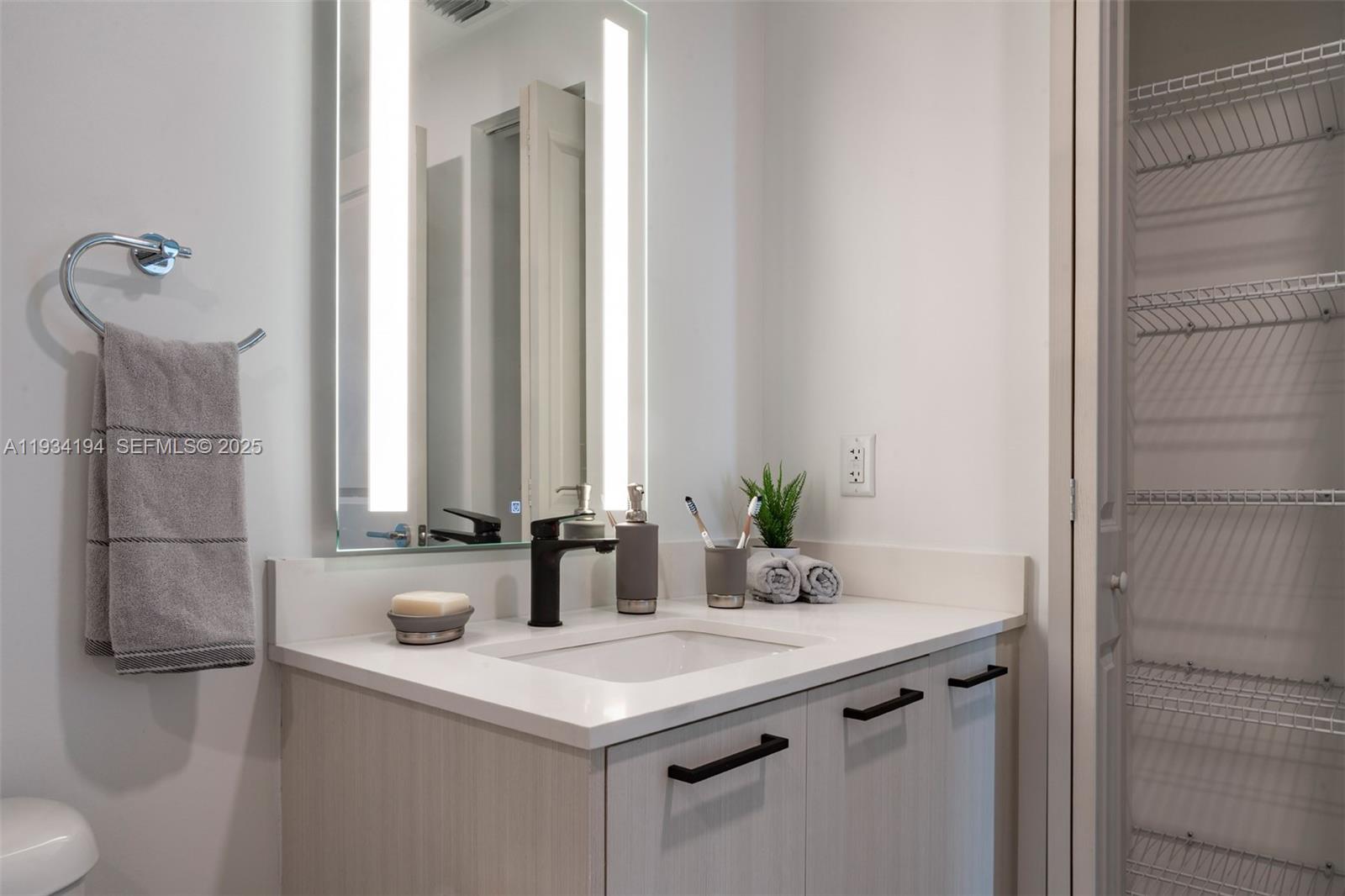 221 Southwest 12th Street, Unit 404 Miami, FL 33130 - Photo 14 of 31 a bathroom with a sink and a mirror