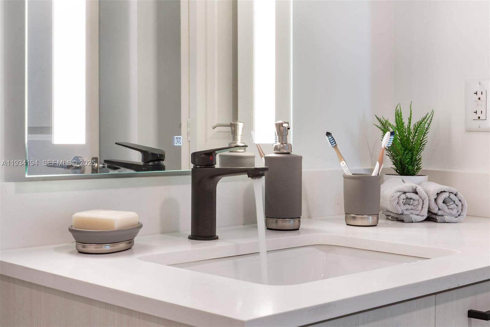 221 Southwest 12th Street, Unit 404 Miami, FL 33130 - Photo 15 of 31 a kitchen with a sink and a potted plant