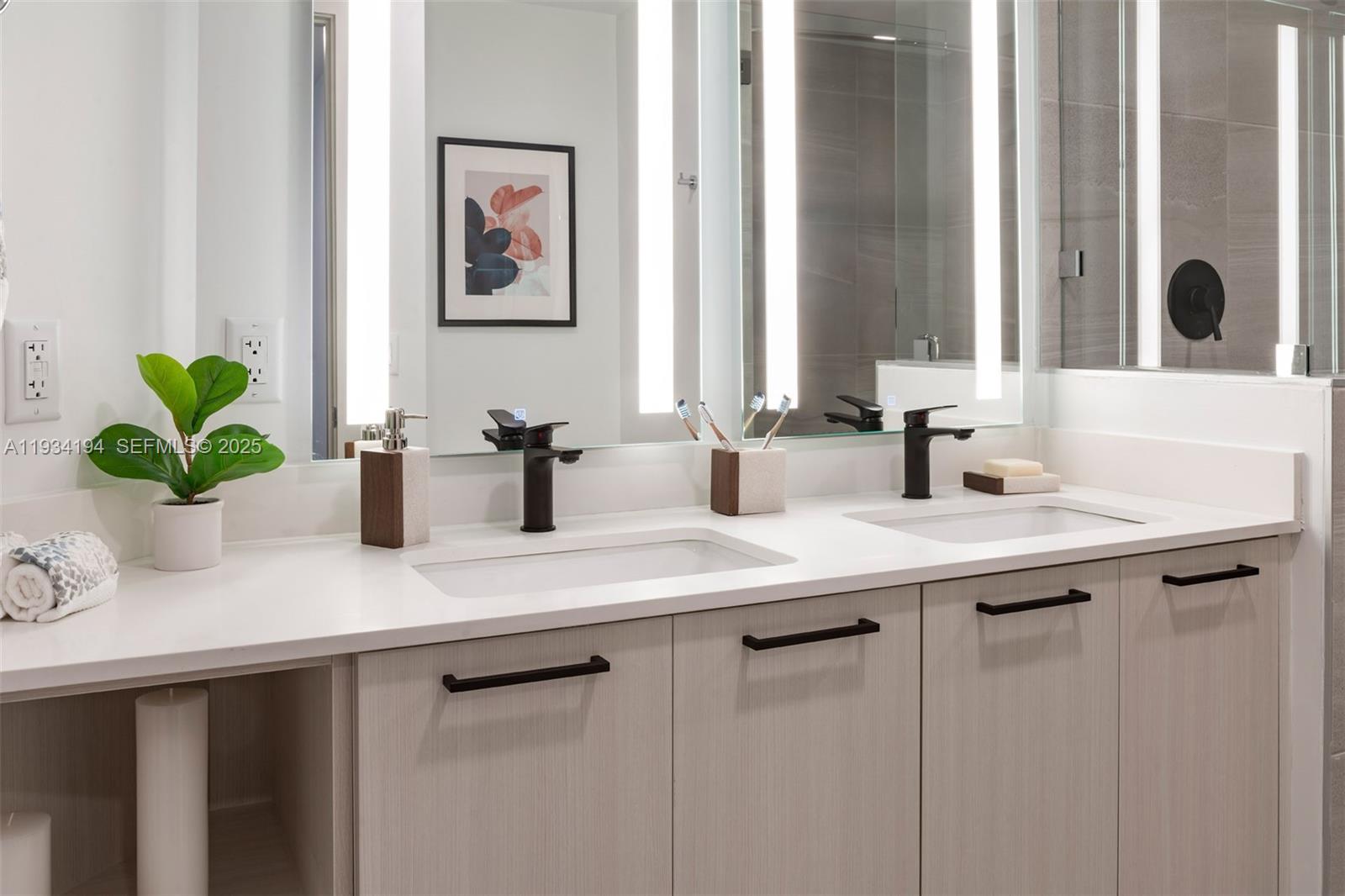 221 Southwest 12th Street, Unit 404 Miami, FL 33130 - Photo 17 of 31 a bathroom with a sink a potted plant and a window