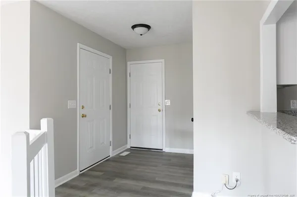a view of a hallway with wooden floor