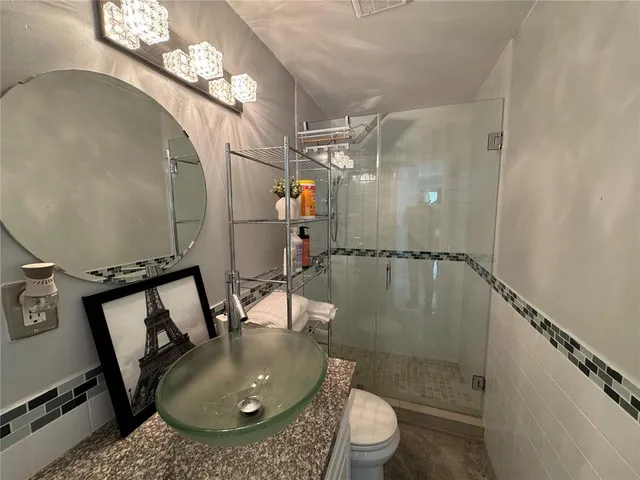 a bathroom with a sink toilet and shower