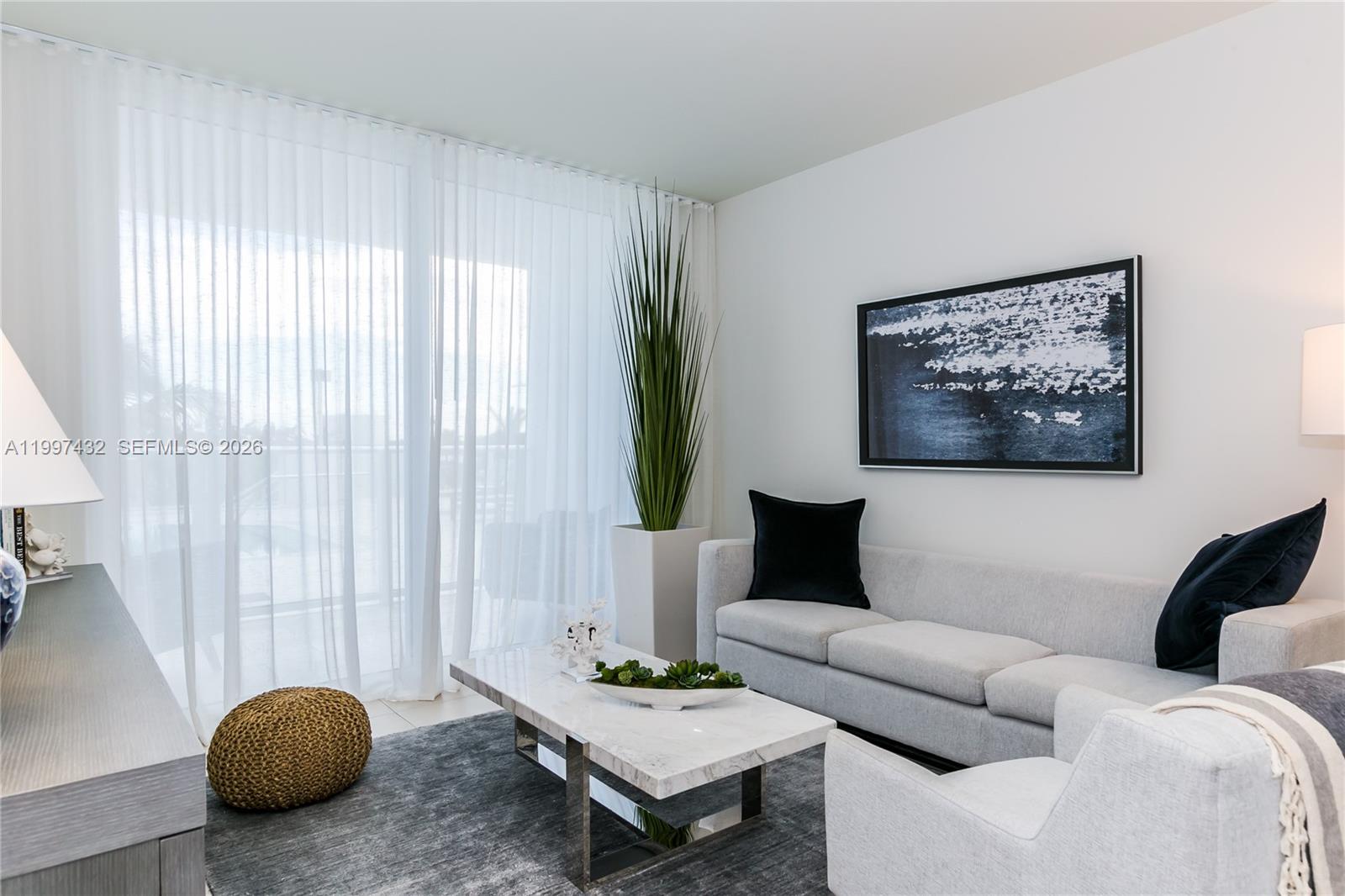 401 North Birch Road, Unit 404 Fort Lauderdale, FL 33304 - Photo 1 of 39 a living room with furniture and a large window