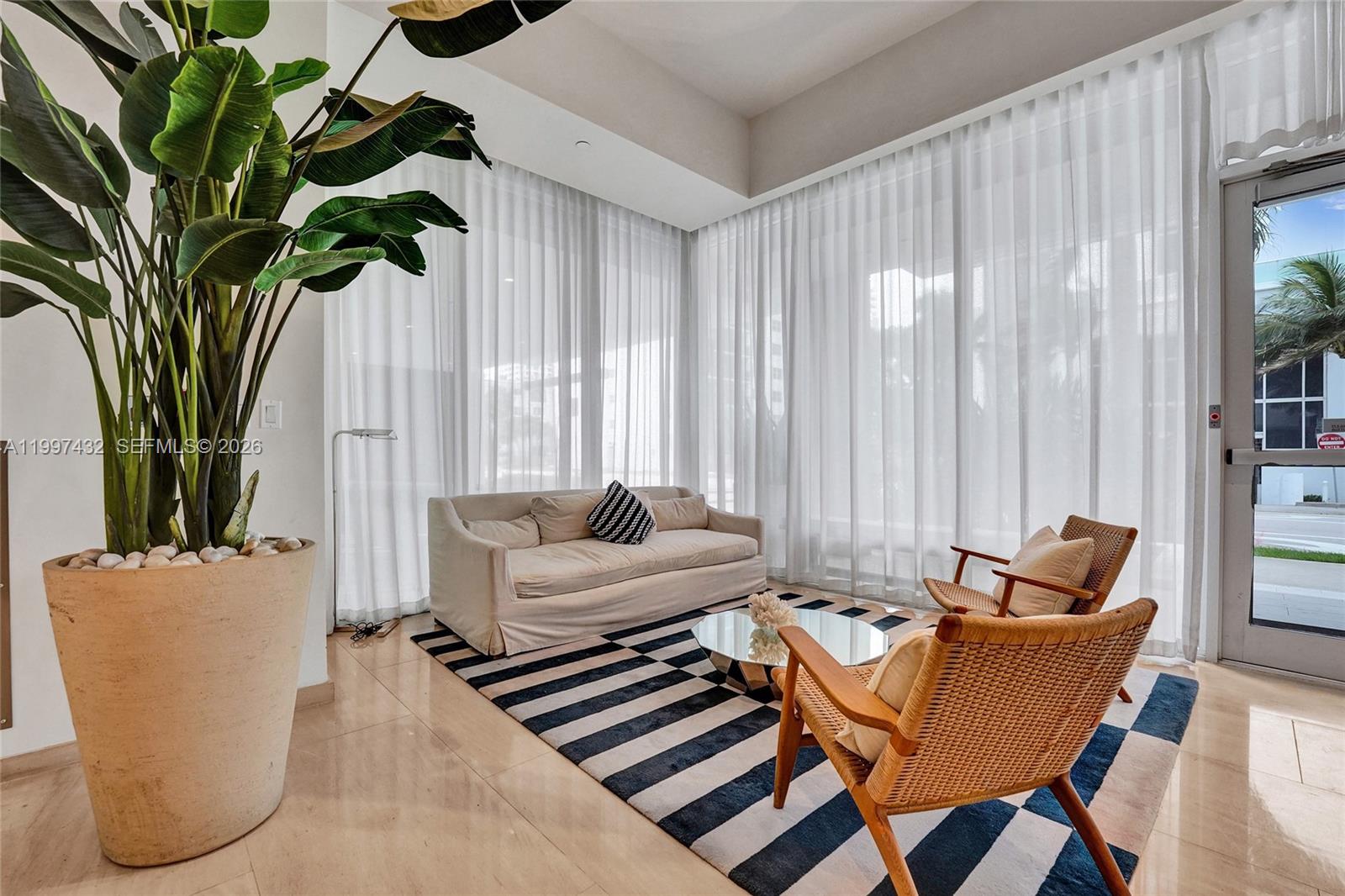 401 North Birch Road, Unit 404 Fort Lauderdale, FL 33304 - Photo 28 of 39 a living room with furniture and a potted plant