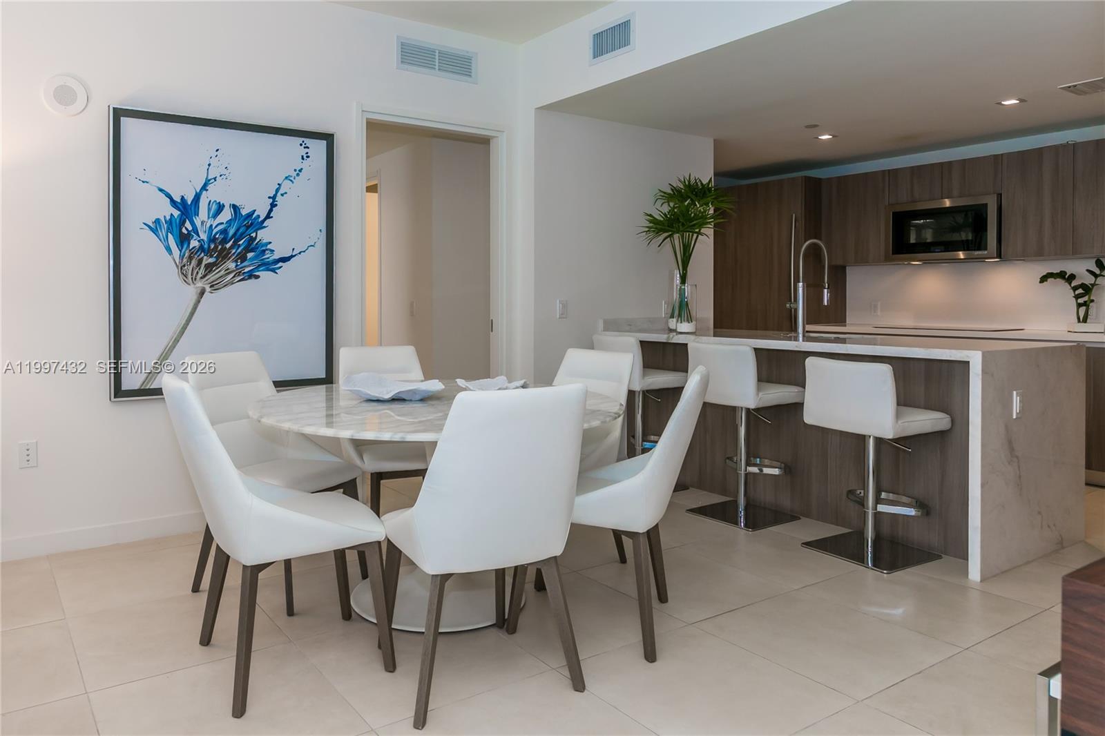 401 North Birch Road, Unit 404 Fort Lauderdale, FL 33304 - Photo 3 of 39 a view of a dining room with furniture