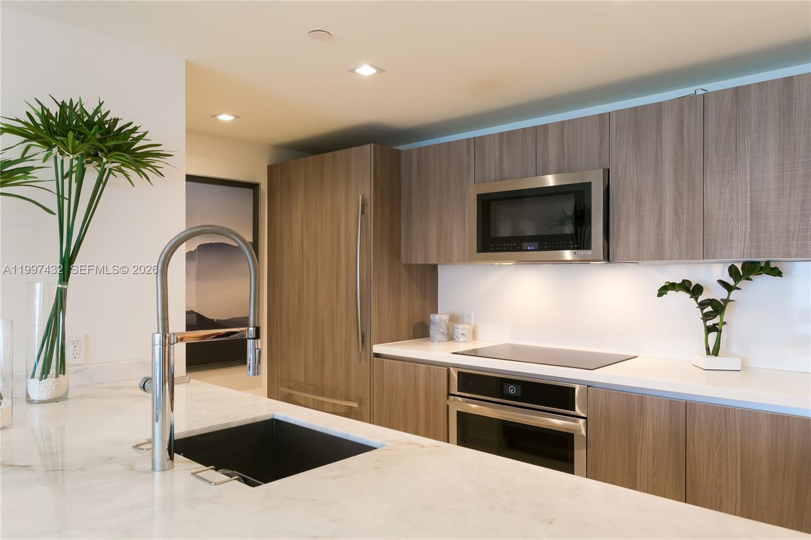 401 North Birch Road, Unit 404 Fort Lauderdale, FL 33304 - Photo 5 of 39 a kitchen with a sink and stainless steel appliances