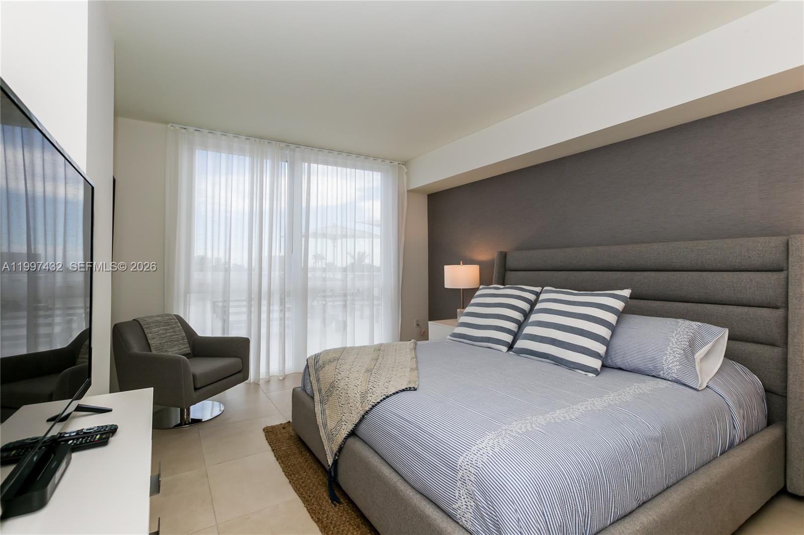 401 North Birch Road, Unit 404 Fort Lauderdale, FL 33304 - Photo 6 of 39 a bedroom with a bed and a couch