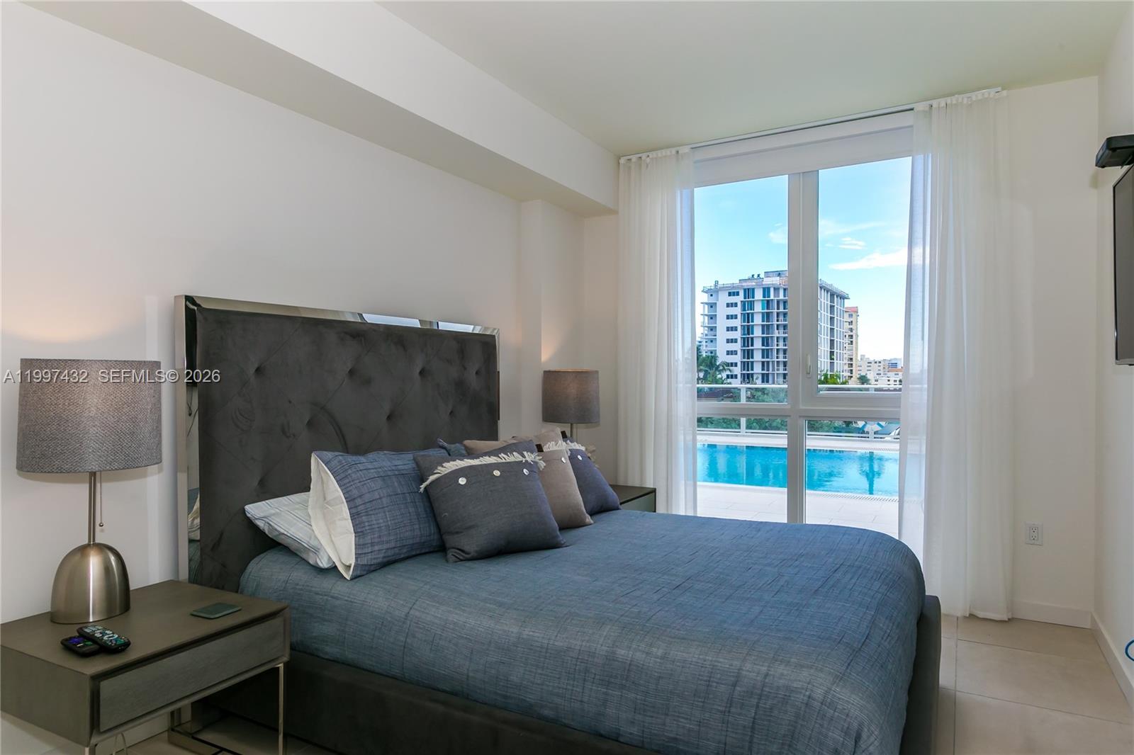 401 North Birch Road, Unit 404 Fort Lauderdale, FL 33304 - Photo 8 of 39 a bedroom with a bed and large window
