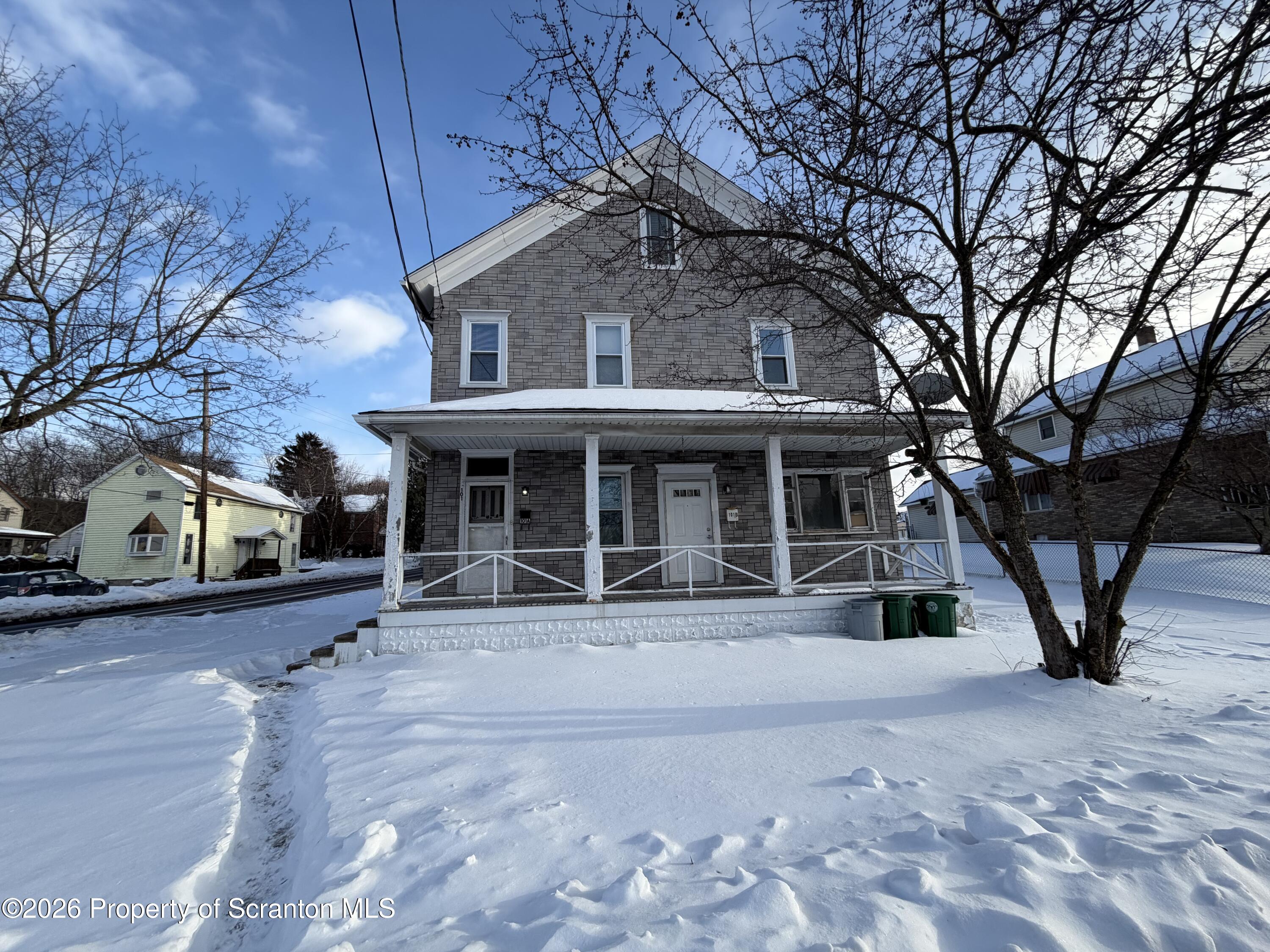 101 Clarkson Street, Unit 2 Jessup, PA 18434 - Photo 1 of 15 a front view of a house with garden