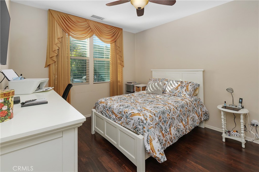 24128 Deputy Way Menifee, CA 92584 - Photo 16 of 34 a bedroom with a bed and a table in it