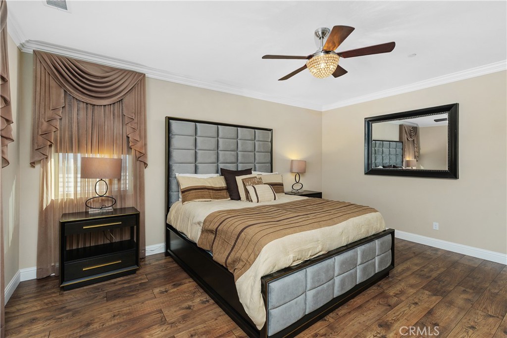 24128 Deputy Way Menifee, CA 92584 - Photo 20 of 34 a bedroom with a bed and a painting on the wall