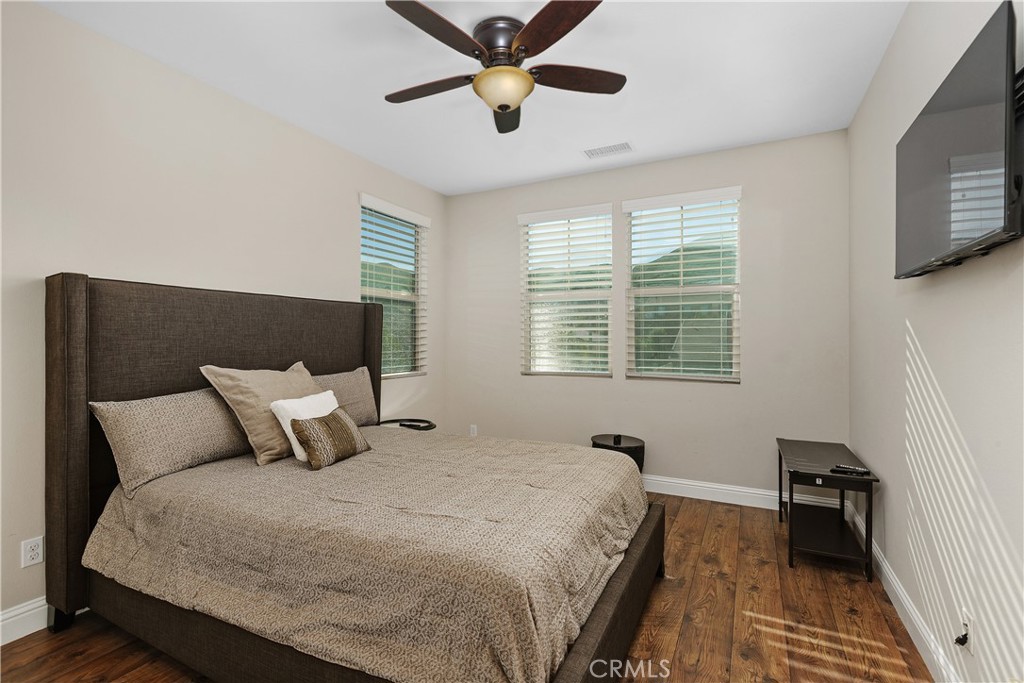 24128 Deputy Way Menifee, CA 92584 - Photo 24 of 34 a bedroom with a bed and a window