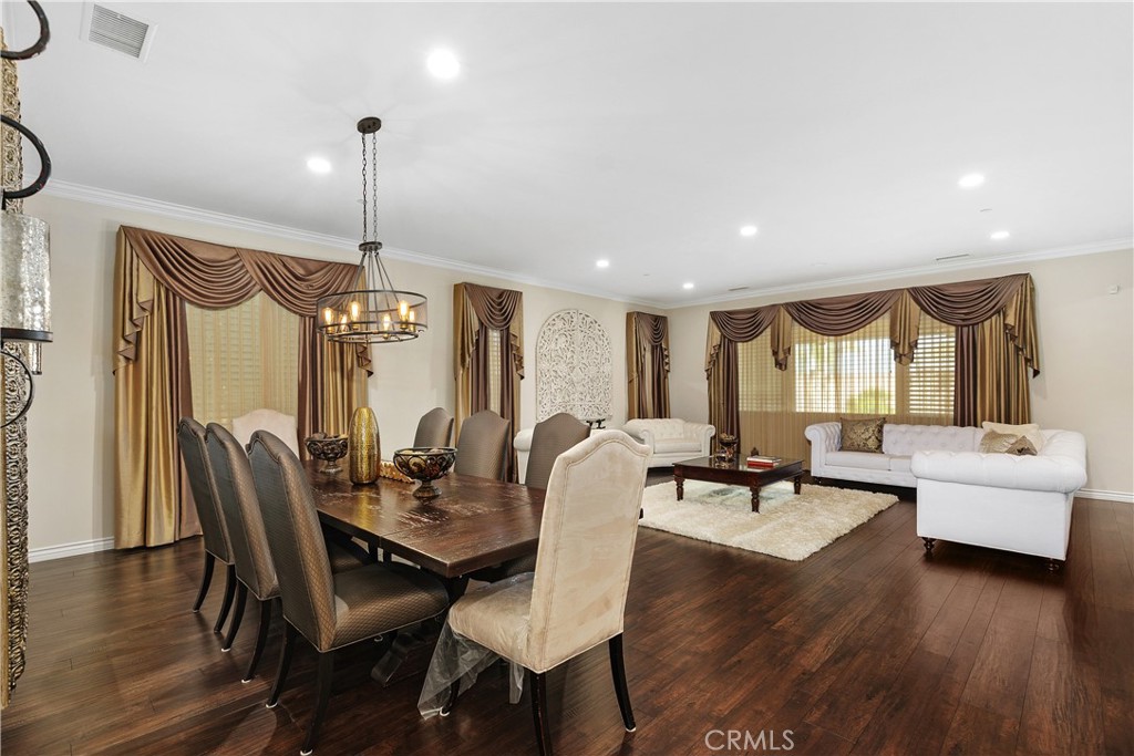 24128 Deputy Way Menifee, CA 92584 - Photo 4 of 34 a view of a dining room with furniture window and wooden floor