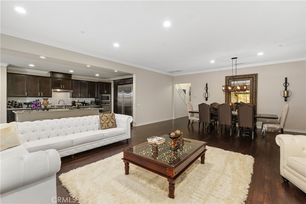 24128 Deputy Way Menifee, CA 92584 - Photo 8 of 34 a living room with furniture and kitchen view