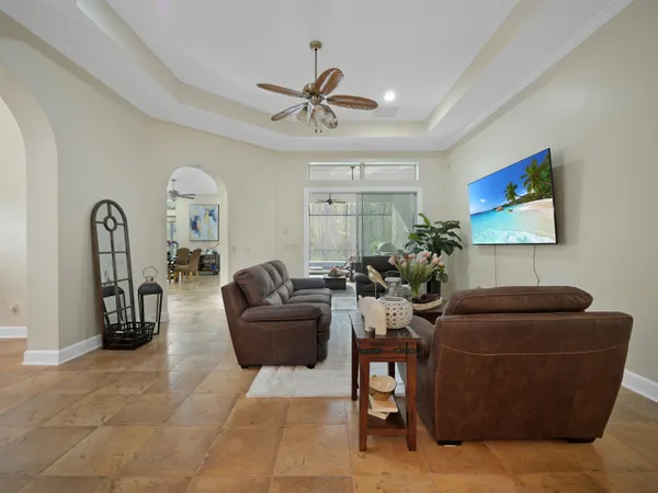 a living room with furniture and a ceiling fan