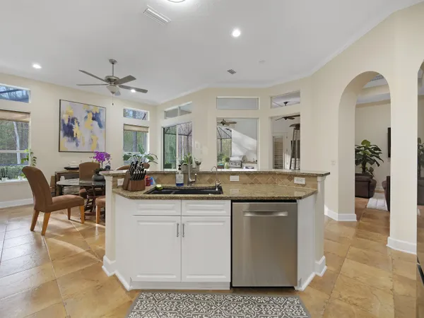 a living room with furniture a wooden floor and a chandelier
