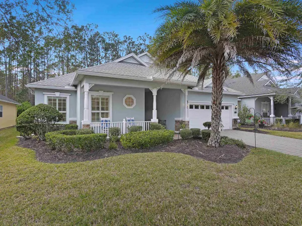 a living room with furniture a chandelier and a bookshelf