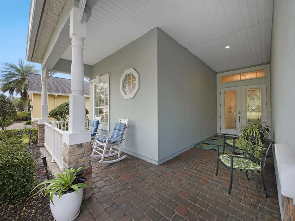 a view of a dining room with furniture and a potted plant