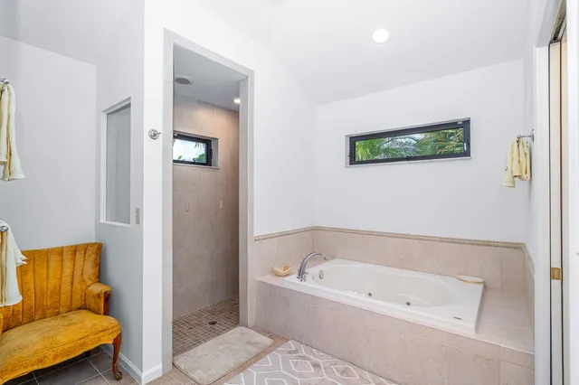 a bathroom with a tub and shower