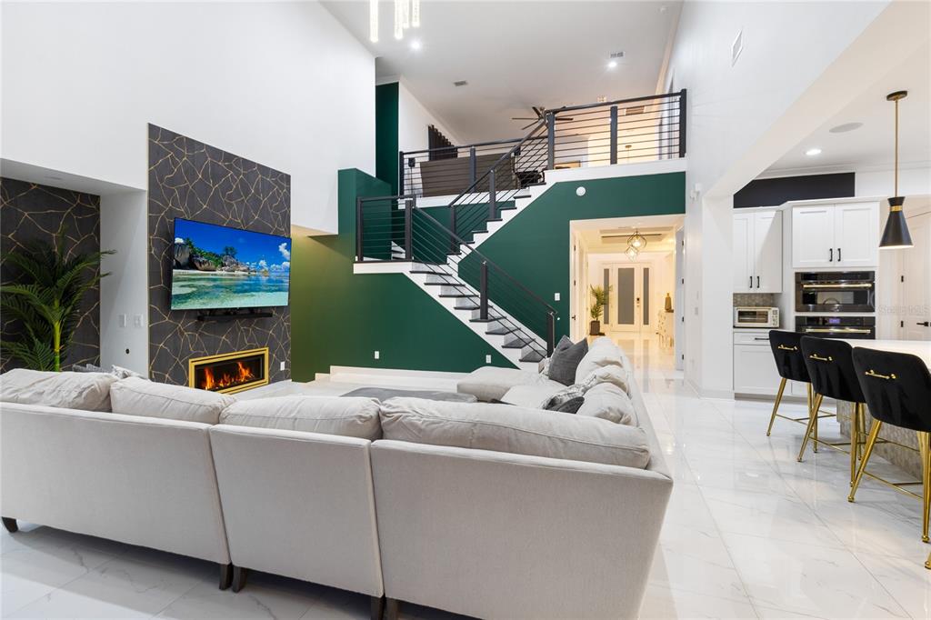 12664 Banting Terrace Orlando, FL 32827 - Photo 13 of 79 a living room with furniture and a fireplace