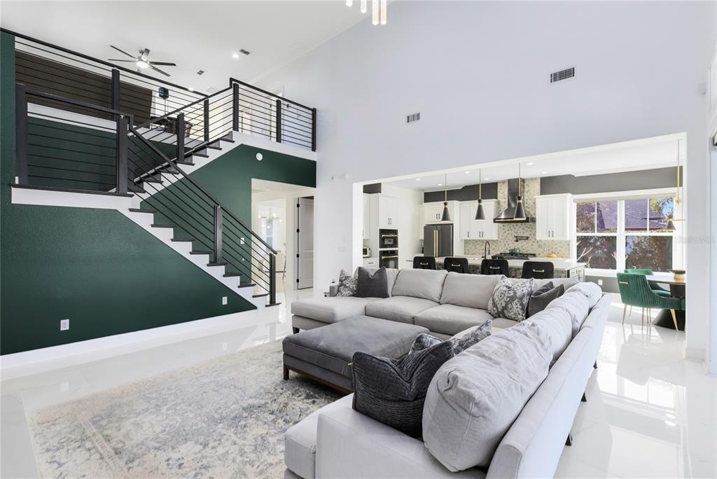 12664 Banting Terrace Orlando, FL 32827 - Photo 14 of 79 a living room with furniture or stairs and a wooden floor