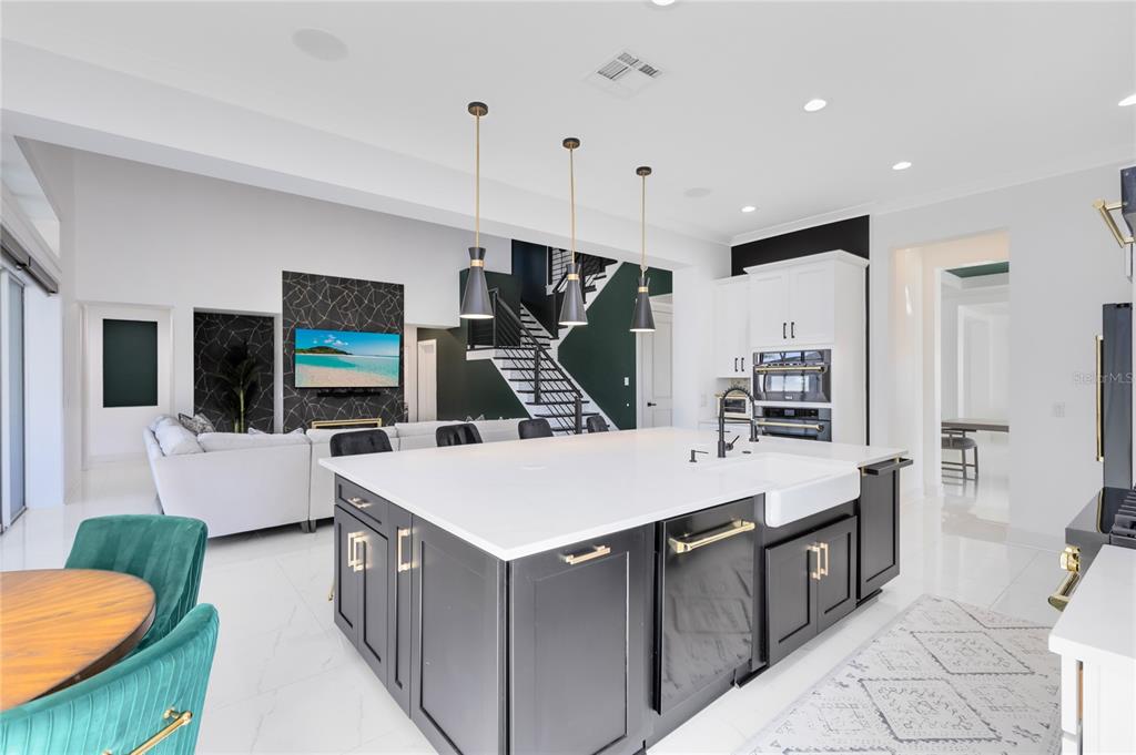 12664 Banting Terrace Orlando, FL 32827 - Photo 20 of 79 a large kitchen with kitchen island a sink a counter space and stainless steel appliances