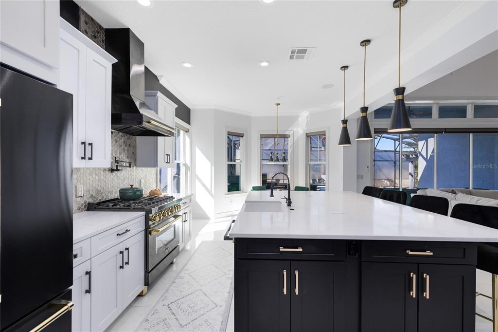 12664 Banting Terrace Orlando, FL 32827 - Photo 21 of 79 a kitchen with stainless steel appliances a sink stove and refrigerator