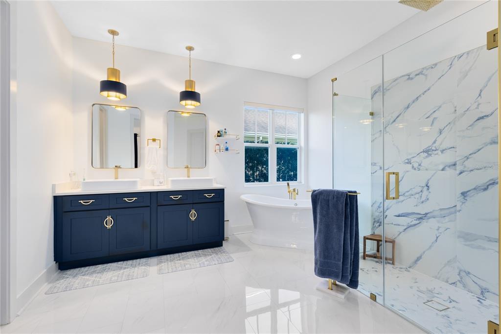 12664 Banting Terrace Orlando, FL 32827 - Photo 25 of 79 a bathroom with a granite countertop double vanity sink and a mirror