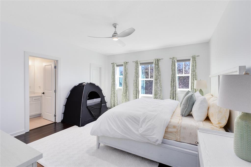 12664 Banting Terrace Orlando, FL 32827 - Photo 36 of 79 a bedroom with a bed and a large window