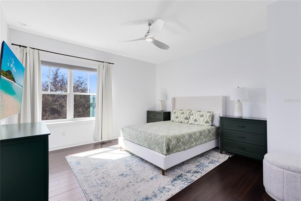 12664 Banting Terrace Orlando, FL 32827 - Photo 37 of 79 a living room with a bed furniture and a window