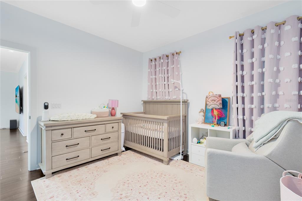 12664 Banting Terrace Orlando, FL 32827 - Photo 39 of 79 a bedroom with furniture and a baby crib