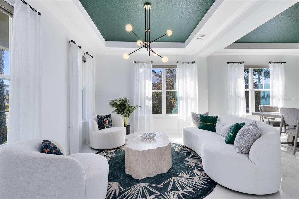 12664 Banting Terrace Orlando, FL 32827 - Photo 8 of 79 a living room with furniture and a chandelier