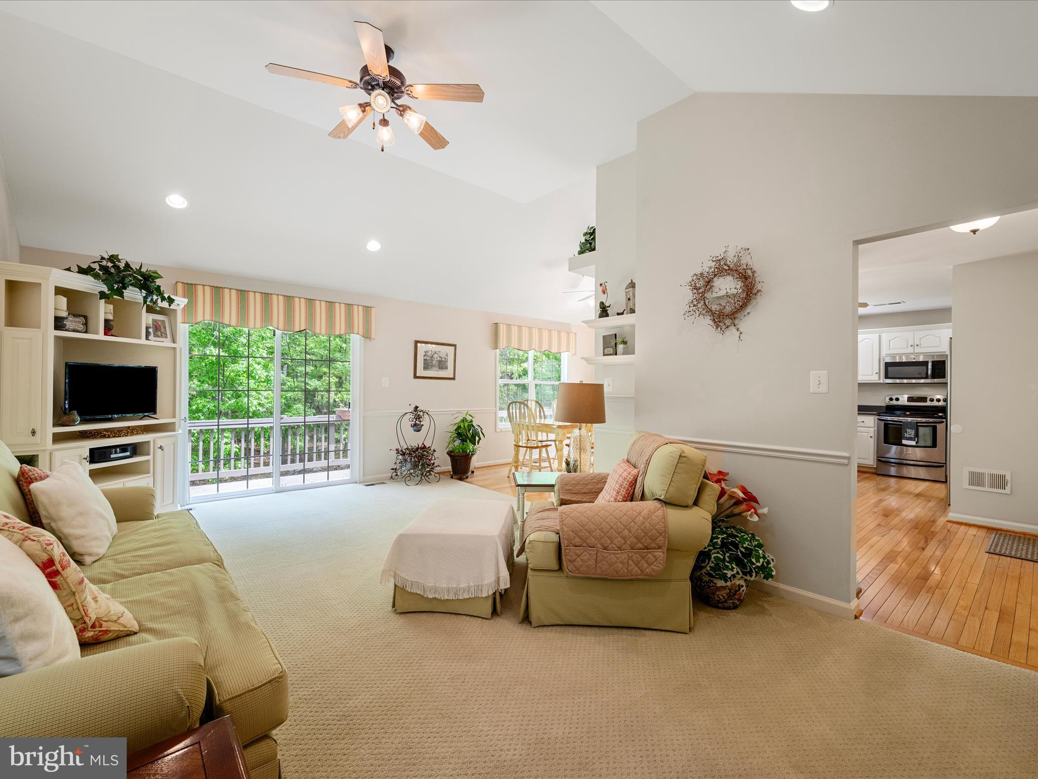 108 Eagle Drive Cross Junction, VA 22625 - Photo 10 of 61 a living room with furniture a flat screen tv and a large window