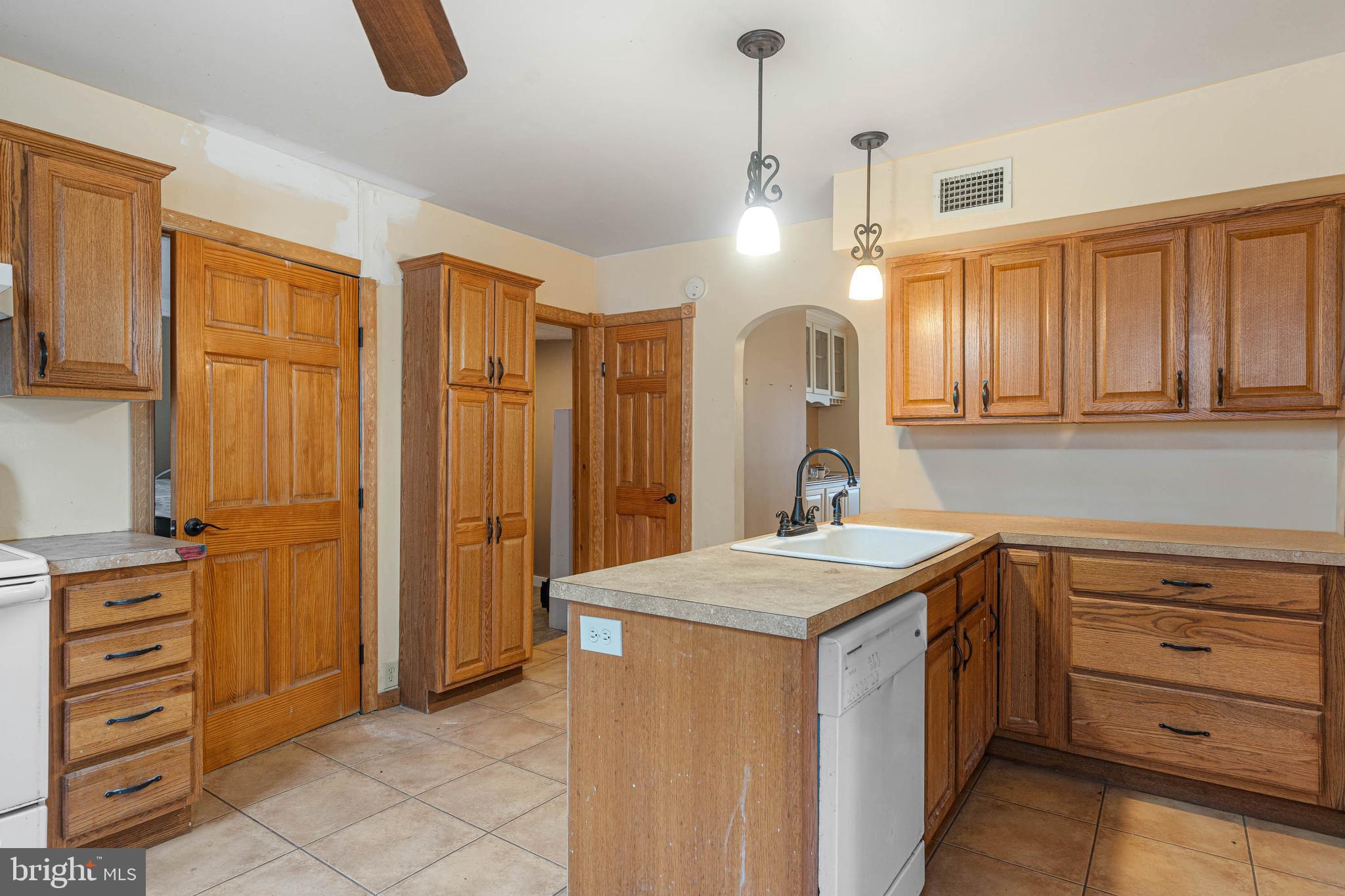 412 East State Street Delmar, MD 21875 - Photo 11 of 36 a kitchen with a refrigerator a sink and cabinets