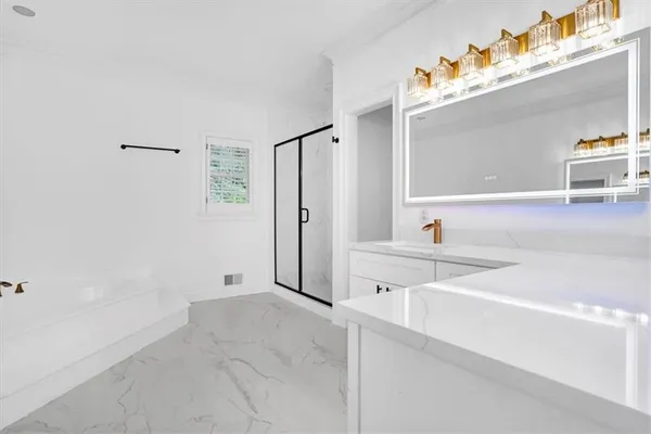 a spacious bathroom with a double vanity sink a mirror and a bathtub