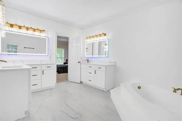 a spacious bedroom with a bed and window