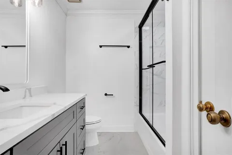 a spacious bedroom with a bed and a chandelier