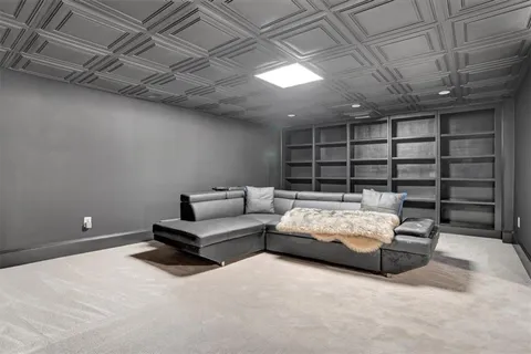 a bedroom with a bed flat screen tv and window