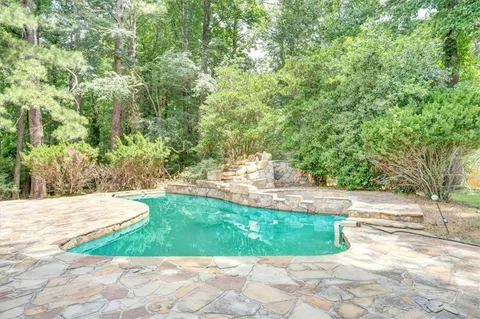 a view of a swimming pool with a patio