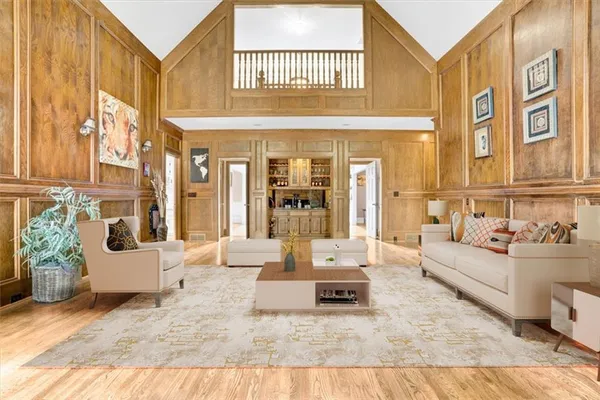 a living room with furniture fireplace and a large window