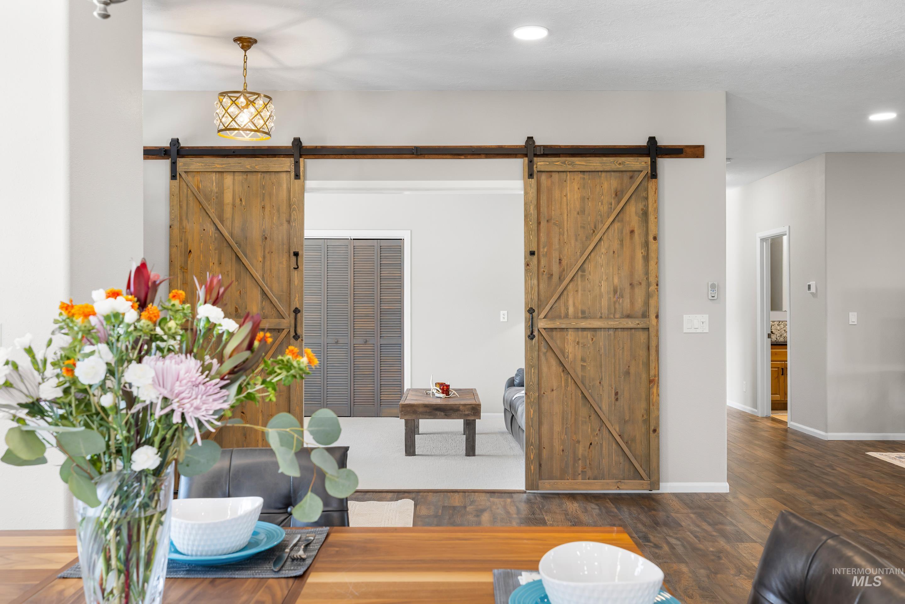 14119 Silver Ridge Road Caldwell, ID 83607 - Photo 12 of 50 Interior space with wood finished floors, recessed lighting, and a barn door