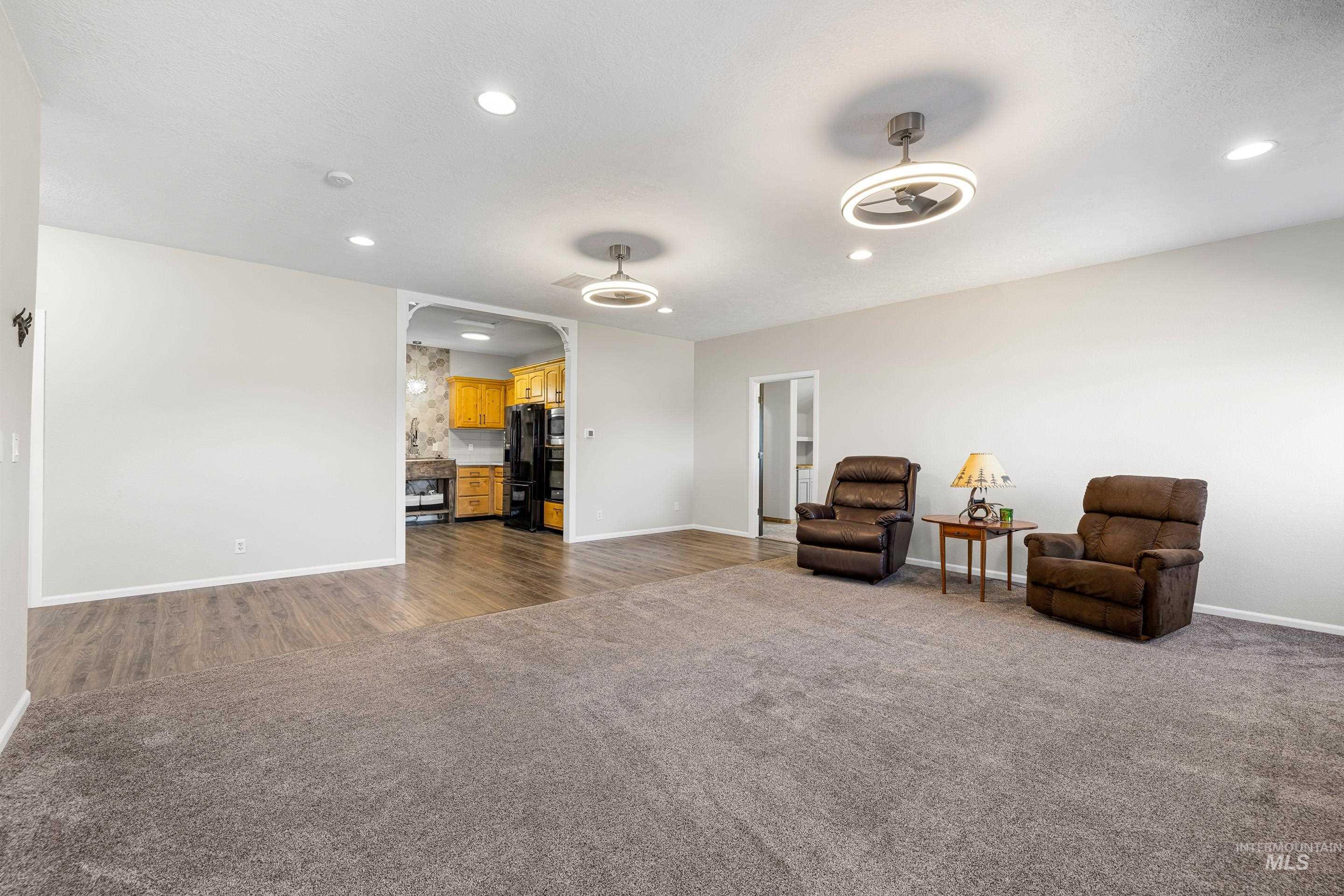 14119 Silver Ridge Road Caldwell, ID 83607 - Photo 29 of 50 Living area with dark carpet, recessed lighting, and arched walkways