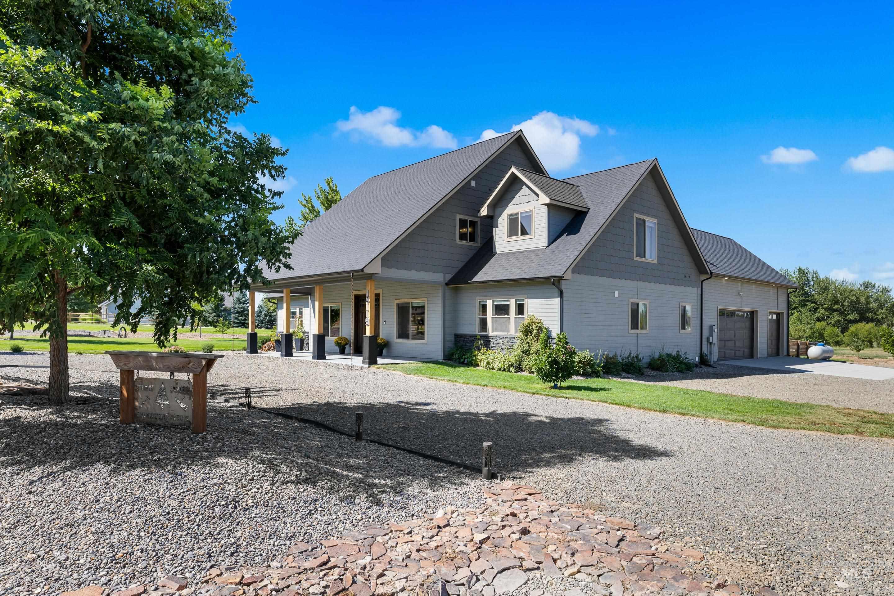 14119 Silver Ridge Road Caldwell, ID 83607 - Photo 3 of 50 View of front of property featuring a garage, a shingled roof, and driveway